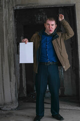 Office worker with problems holding a sheet of paper in the catacombs