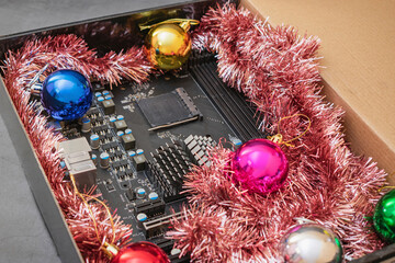 Computer motherboard in a bright gift box for Christmas