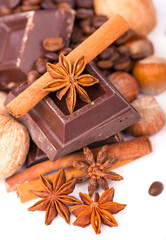 chocolate bars with nuts cinnamon anise and coffee isolated on white background
