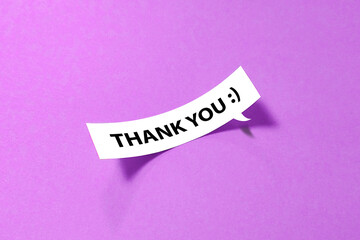 Thank you message on curled speech bubble on purple background
