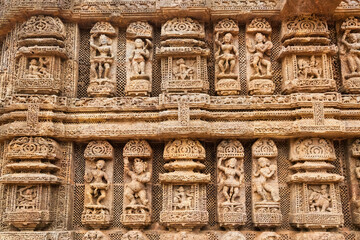 Konark sun temple wall with stone sculptures, carvings and artwork from the 13th century at Puri, Odisha, India