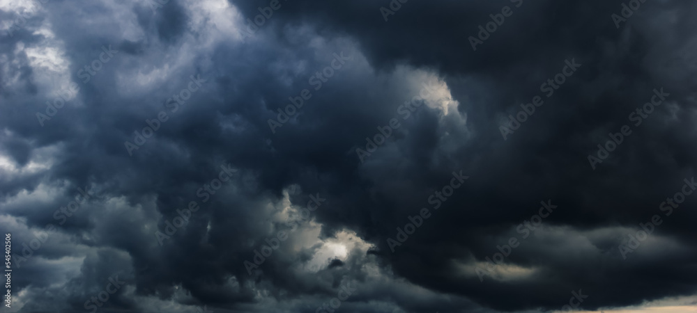 Poster the dark sky with heavy clouds converging and a violent storm before the rain.bad or moody weather s