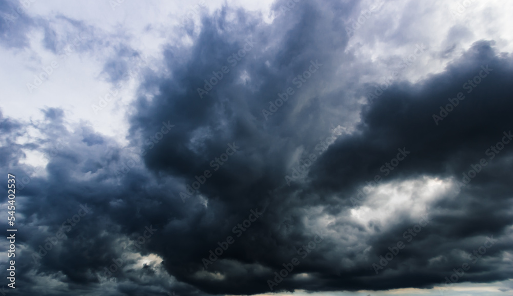 Poster the dark sky with heavy clouds converging and a violent storm before the rain.bad or moody weather s