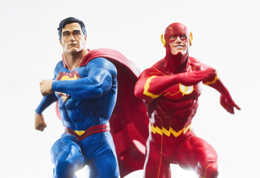 Action figures of superheroes Superman and The Flash in action pose  isolated against a plain white background