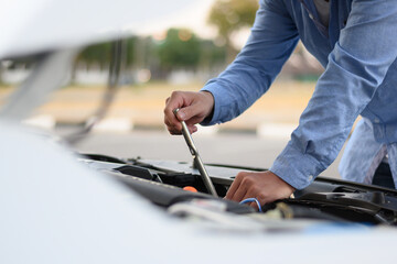 man holding car repair equipment