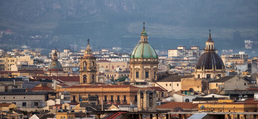 Fototapeta na wymiar Residential Homes and Historic Church Buildings with mountains in background in Palermo, Sicily, Italy. Sunrise Sky.