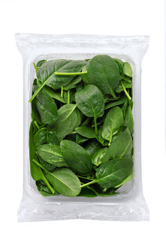 Baby spinach, Isolated on White Background – Close-Up Macro, plastic Package Wrapped in Clear Plastic - Top View, Macro Close Up