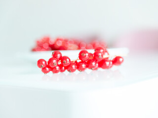 A bunch of red currants on a white background