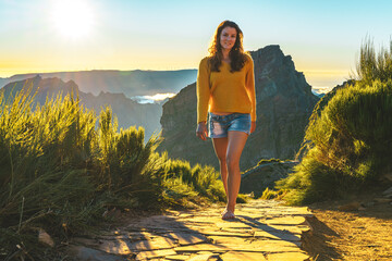 Sporty woman walking barefoot in the evening sun on Pico do Ariero on a super beautiful hiking...