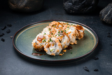 Japanese food sushi rolls with shrimp, Philadelphia cheese, avocado, cashews, teriyaki sauce with caramel.