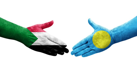 Handshake between Sudan and Palau flags painted on hands, isolated transparent image.