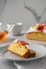 Slice of Orange pound cake with fresh bloody orange. Vertical