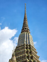 The top of the beautiful chedi contrasts with the blue sky at Wat Pho or Wat Phra Chetuphon....