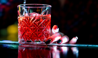 bartender making negroni cocktail in bar