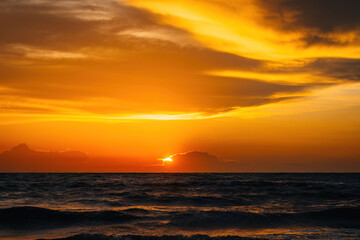 Naklejka na ściany i meble Beautiful view of the sea during golden sunset.