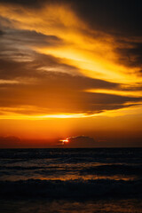 Naklejka na ściany i meble silhouette of the beach during golden sunset.