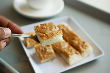 top view of peanut butter and a bread on plate on black background 