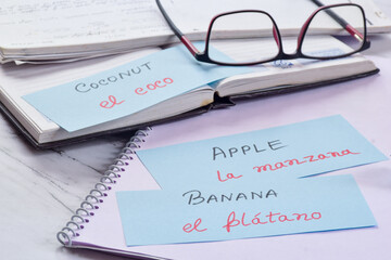 Learning new language with fruits name in flash cards; Spanish. Selective focus on the text.