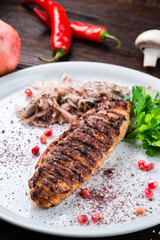 Georgian food chicken kebab, grilled chopped chicken fillet with spices and herbs, pomegranate seeds, onion.