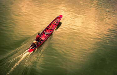 Red boat sailing in the river