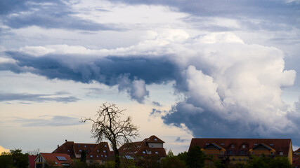 Ominous big cloud over city buildings