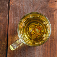tea cup transparent lemongrass on wooden table top view.