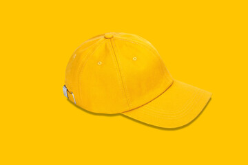 Yellow baseball cap isolated on yellow background. Mock up for branding.