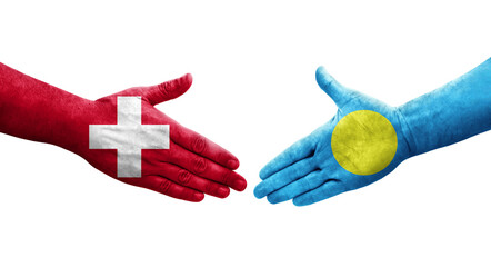 Handshake between Switzerland and Palau flags painted on hands, isolated transparent image.