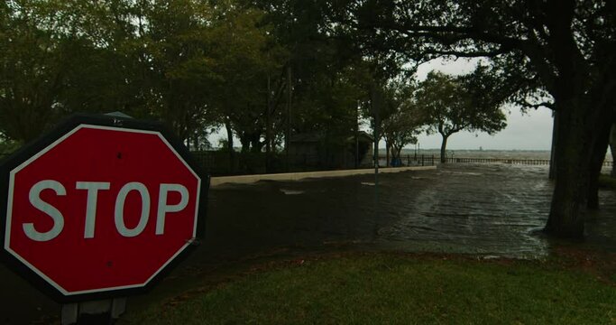 Florida Hurricane river flooding street stop sign wind damage building flooded road