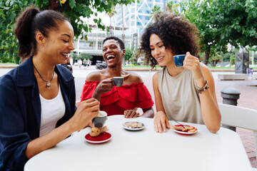 Three mixed race hispanic and black women bonding outdoors