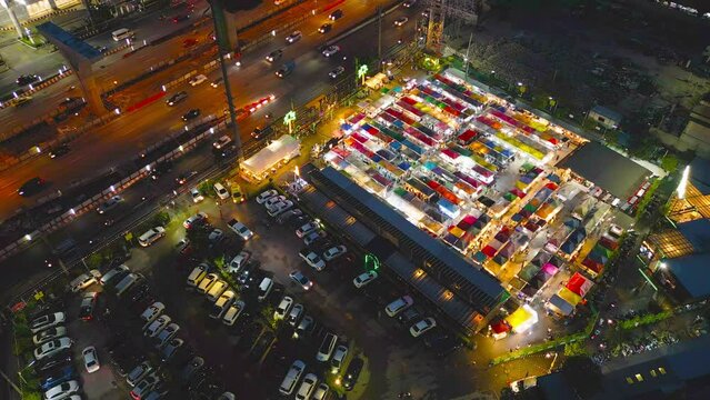 Aerial top view of Night Market people walking street, Colorful tents in the train of Ratchada at Bangkok city, Thailand. Retail shops