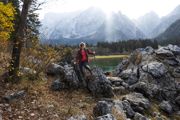 Hiker Enjoying a Morning Walk Around Alpine Lake of Fusine, Italy