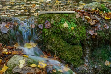 Fototapeta premium christmas sign on a river waterfall with silk effect