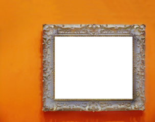 Beautiful antique wood carving empty photo frame isolated on orange colored wall, cutout, copy space