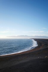 Vertical of beautiful Hvalnes beach with black sand in Iceland.