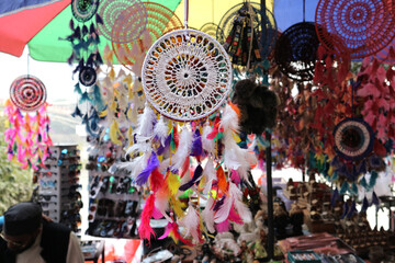 White dreamcatcher with colorful feathers in a souvenir shop in Rishikesh, Uttarakhand, India.