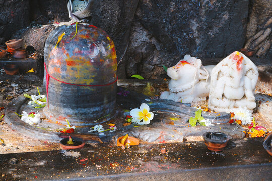 Traditional Hindu altar of Shiva under a tree. Shiva lingam, Ganesh and Nandi bull.