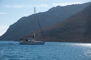 Aerial view of boat sailing on sea surrounded by mountains