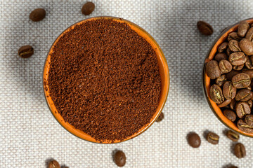 coffee beans, ground coffee in cups on a linen background