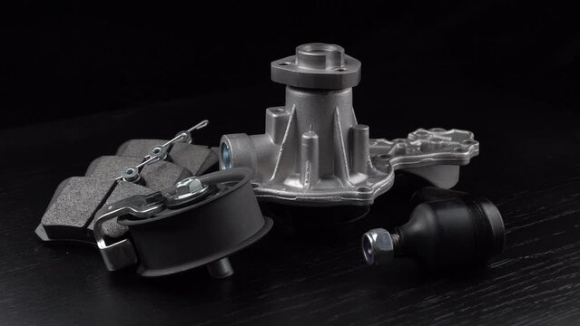 Auto parts spare parts car on grey background. Large number rotate on turntable around its axis. Auto parts store. Suspension and engine parts.