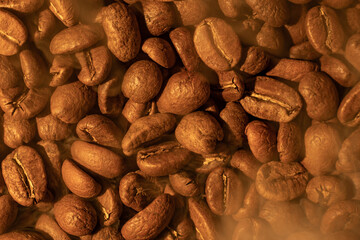 Texture of coffee beans, light soft light and steam from coffee.