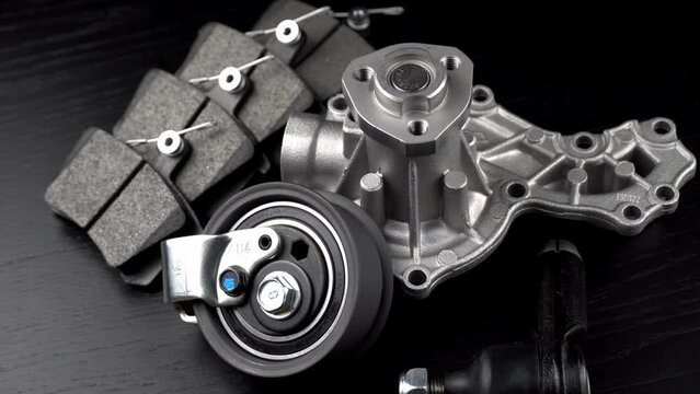 Auto parts spare parts car on grey background. Large number rotate on turntable around its axis. Auto parts store. Suspension and engine parts.