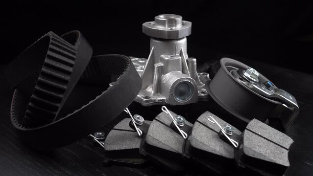 Auto parts spare parts car on grey background. Large number rotate on turntable around its axis. Auto parts store. Suspension and engine parts.