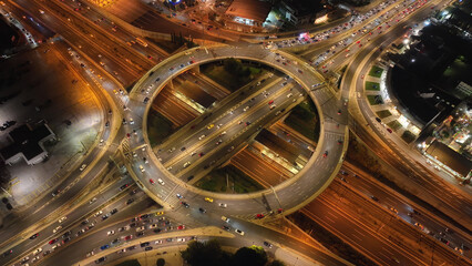 Aerial drone night photo of illuminated urban elevated toll ring road junction and interchange overpass passing through Kifisias Avenue, Attica, Greece