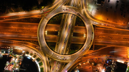 Aerial drone night photo of illuminated urban elevated toll ring road junction and interchange...
