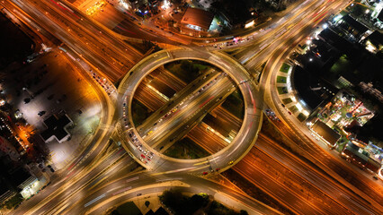 Aerial drone night photo of illuminated urban elevated toll ring road junction and interchange...
