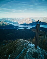 Beautiful view of a Cross on a snowy mountain on a sunny day in Monte Croce, Lombardia
