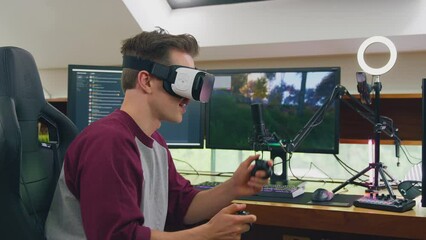 Male gamer wearing VR or AR headset at home  live streaming shooting game online  - shot in slow motion