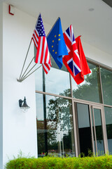 The US, EU, UK, and Moroccan flags hanging on the entrance of a luxury hotel
