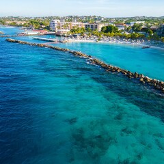 Obraz premium Aerial of the blue ocean and the beautiful Mambo beach in Curacao on a sunny day